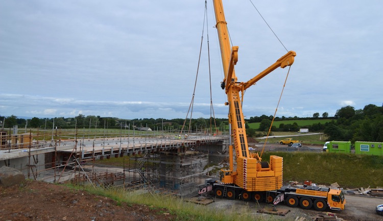 Crane lifting a beam into place.