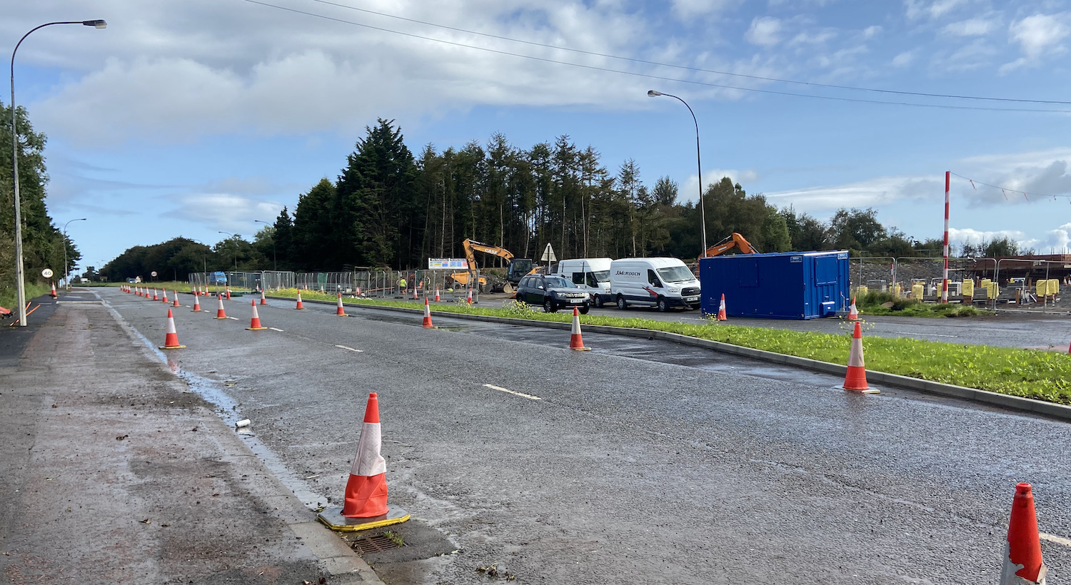 Two lanes coned to one with construciton
                          vehicles opposite.