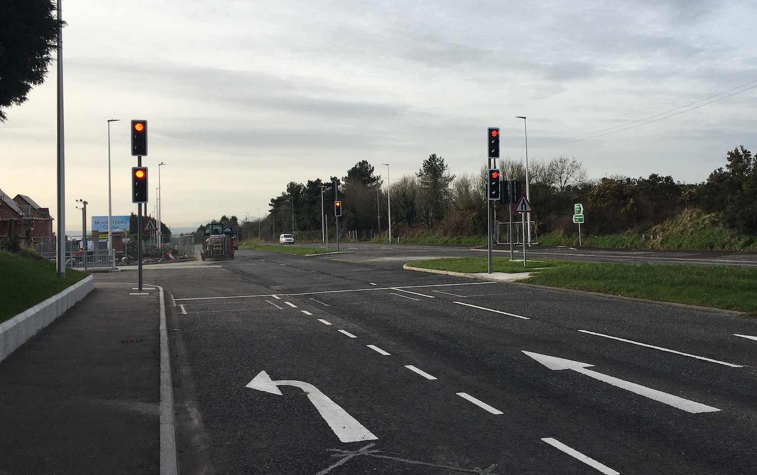 View along a road towards traffic signals
                          with two straight on lanes and one turn left
                          filter lane.