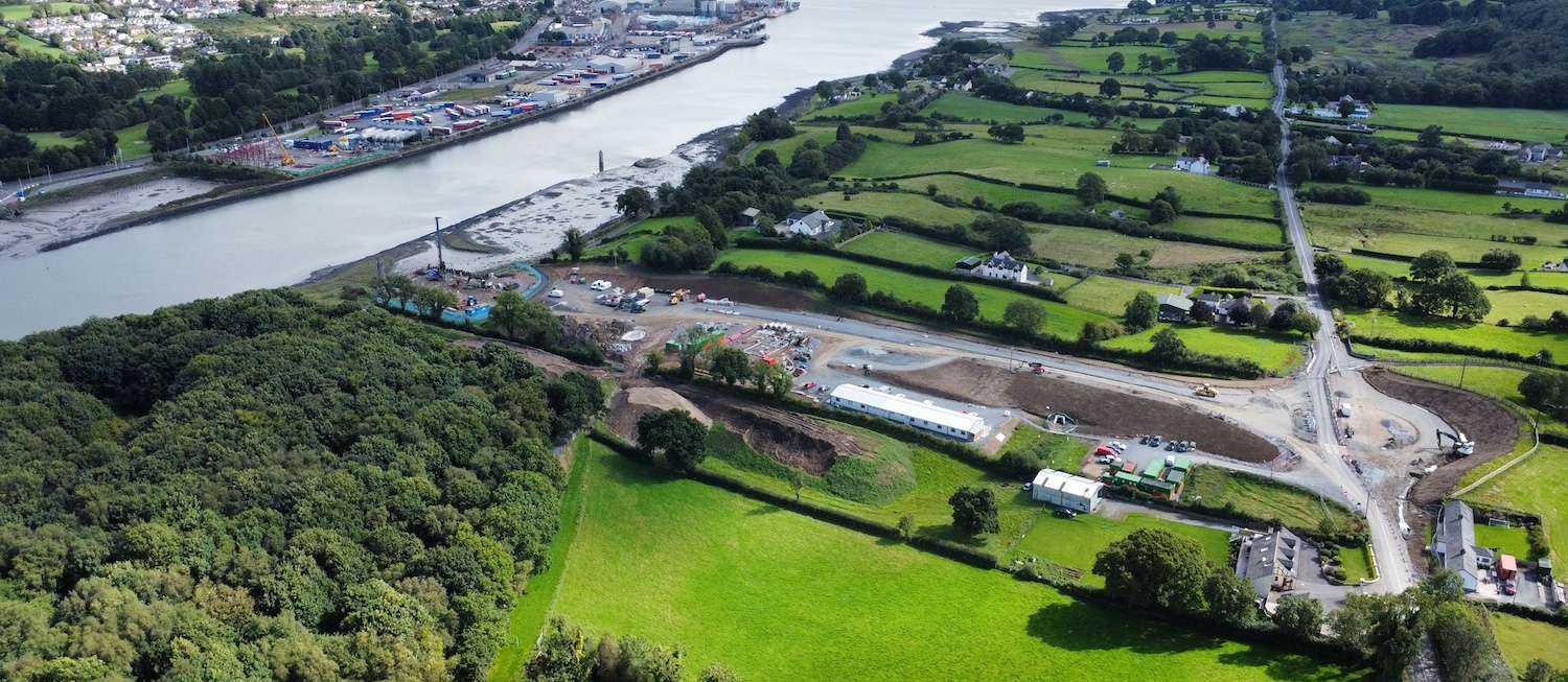 Newry river on left, building site
                          extending to the right with a new roundabout
                          taking shape on the right and a new road
                          heading left from it.