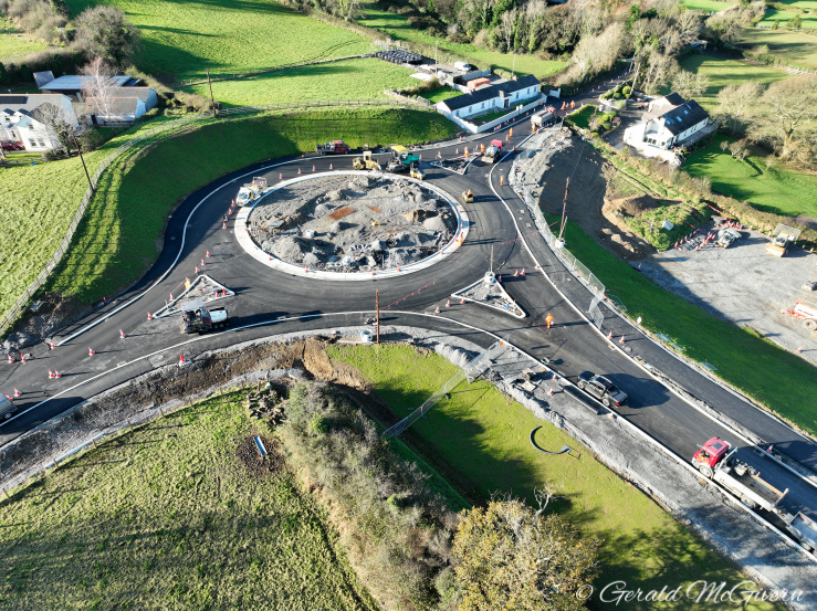 Roundabout in centre of shot with all
                          traffic moving around the far side only.