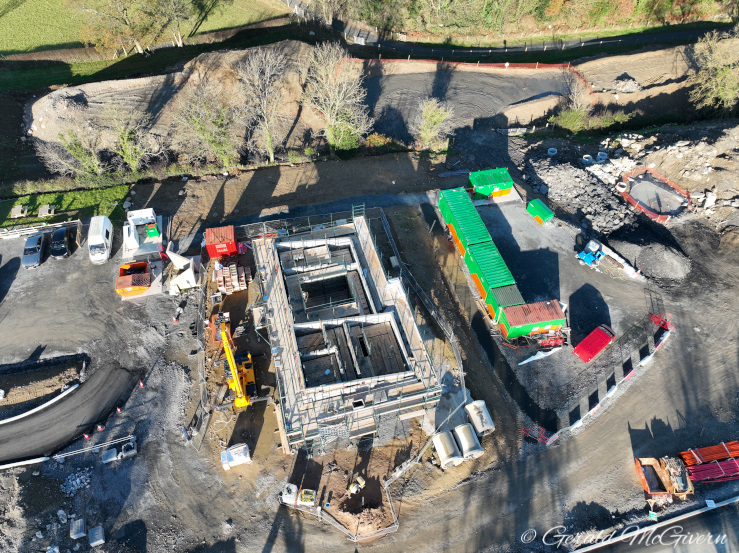 Looking down on a small concrete building
                          under construction, about a metre above ground
                          level.