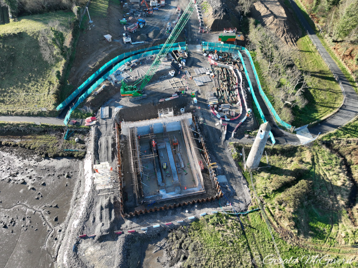 Looking down on a large square foundation
                          with lots of rebar and concrete visible.