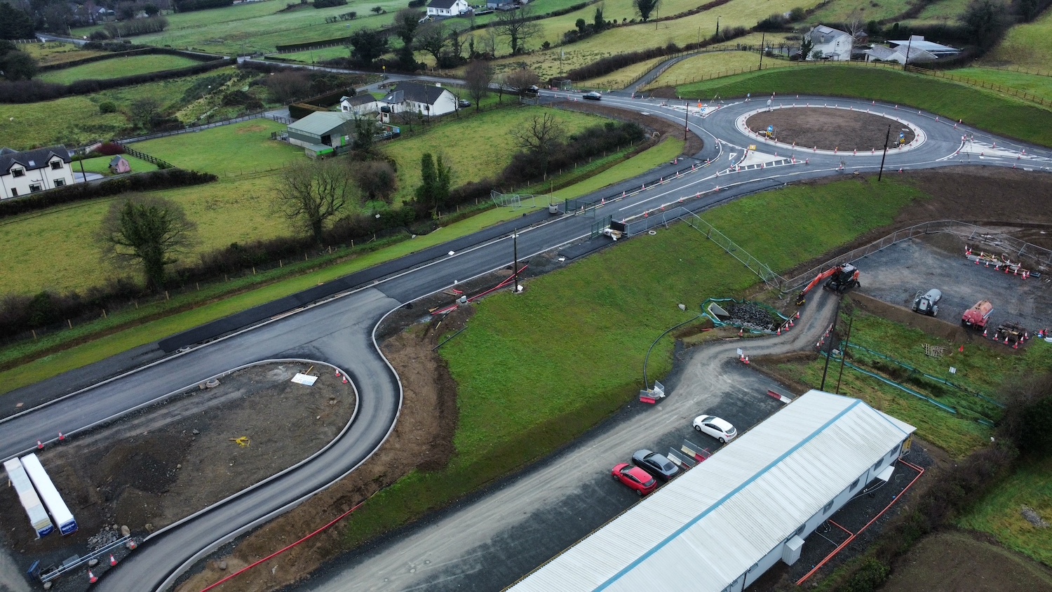 A roundabout at top left with a road
                          running to bottom left.