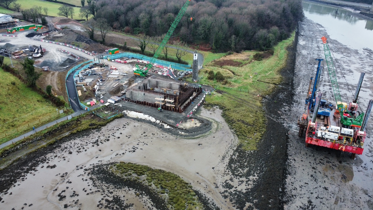 Foundations for bridge pier on left, with
                          a small area of mud and then a platform in the
                          water to the right.